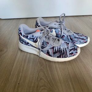 Grey patterned Nike running shoes